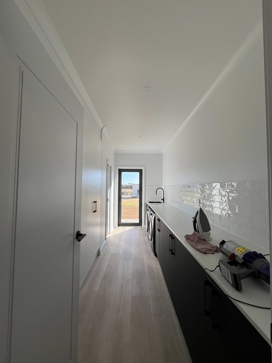 Long laundry galley with subway tile splashback