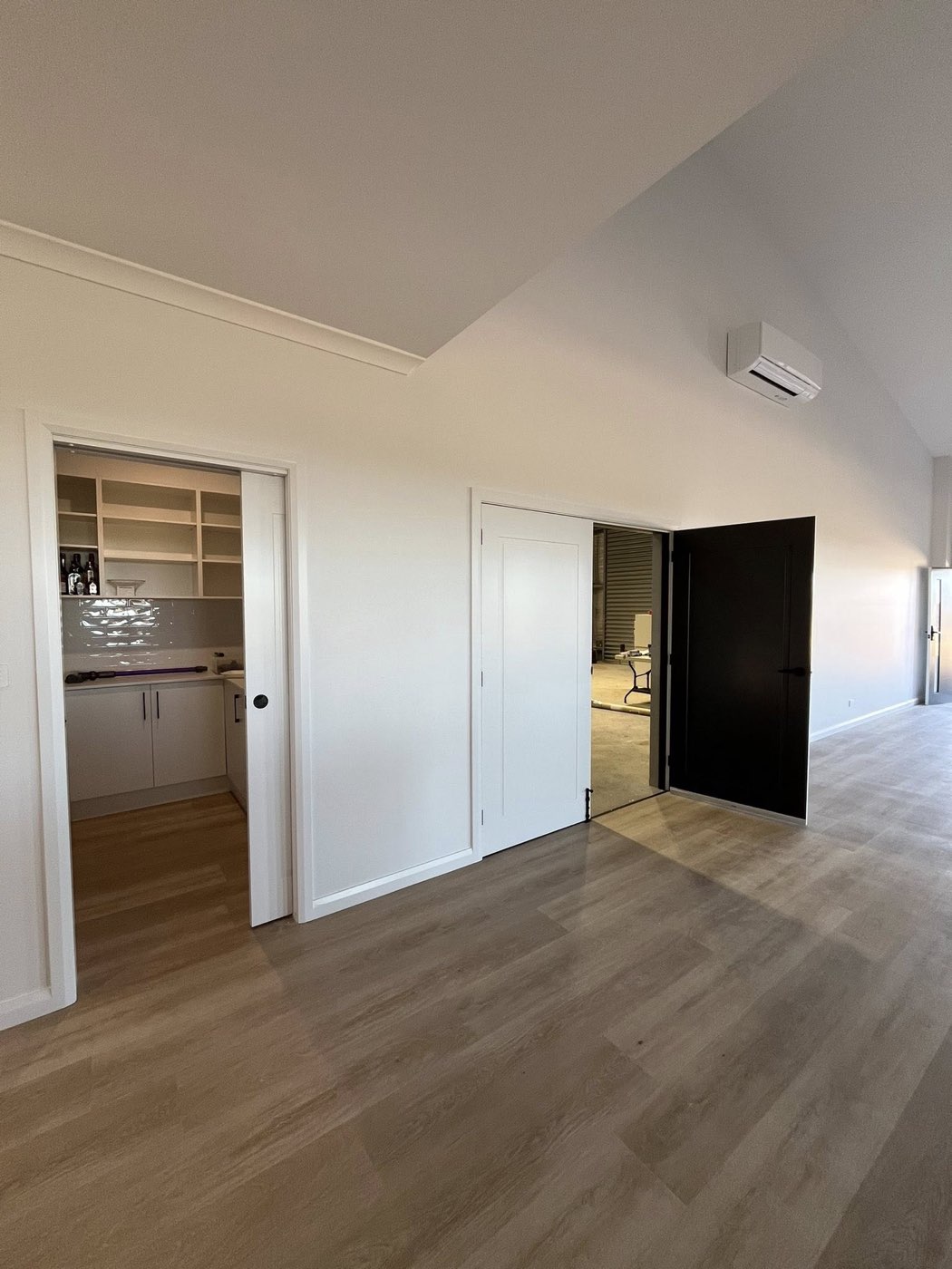 Living room with raked ceiling and butler's pantry