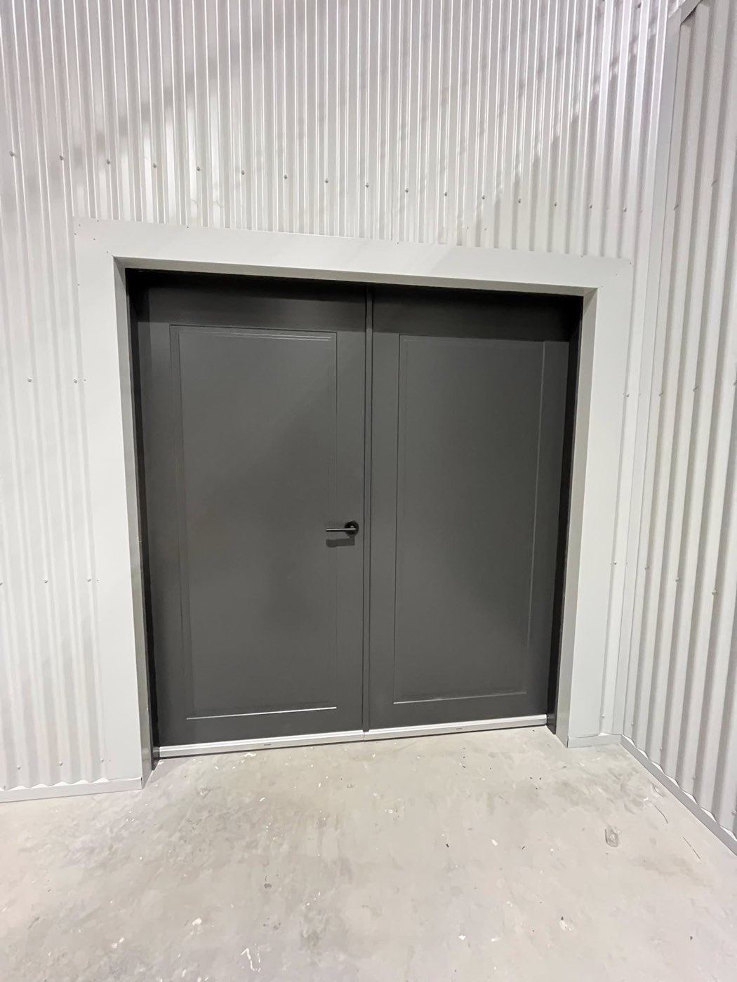 Industrial double doors in painted shed interior