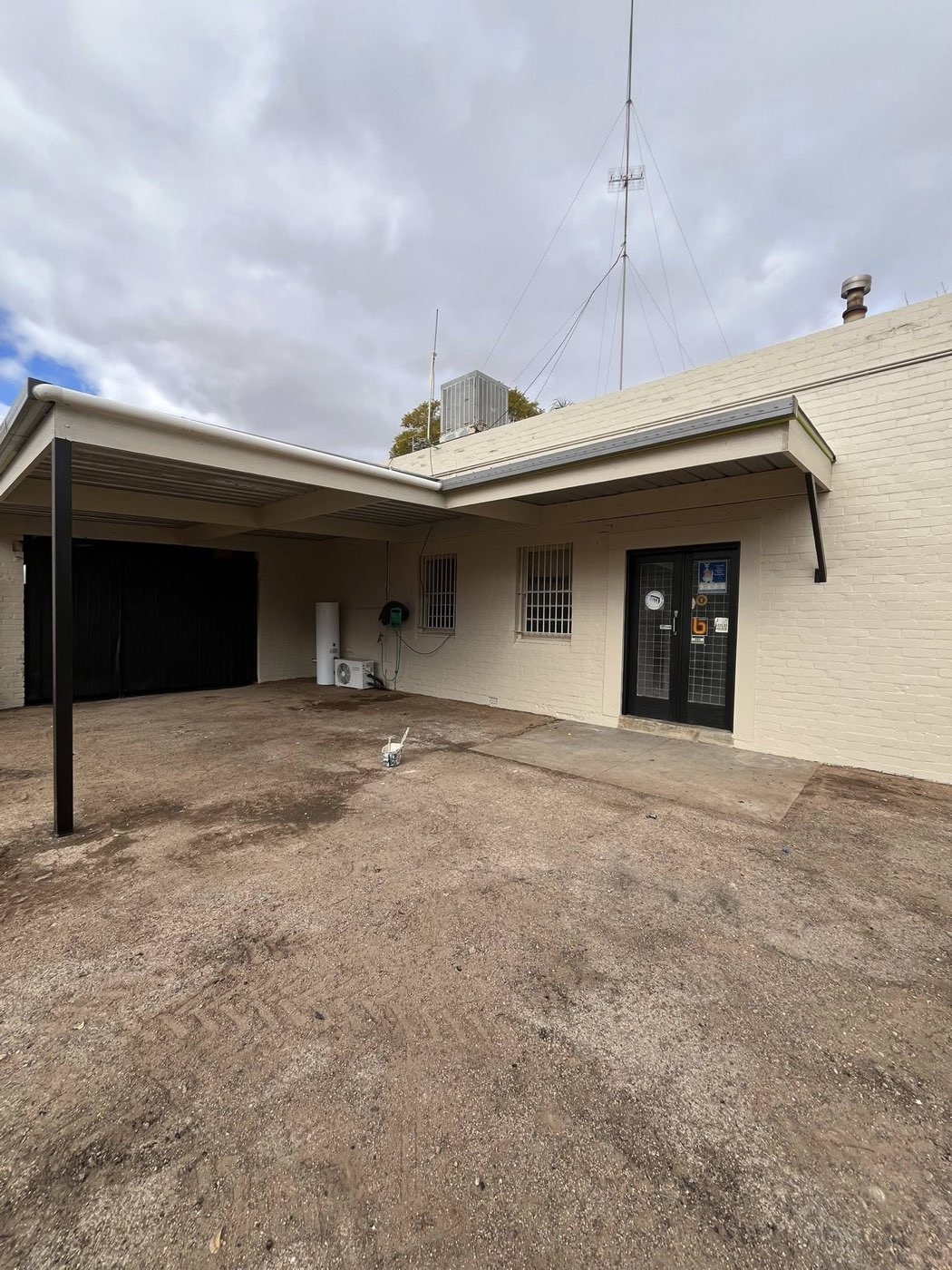 Painted commercial building with side carport