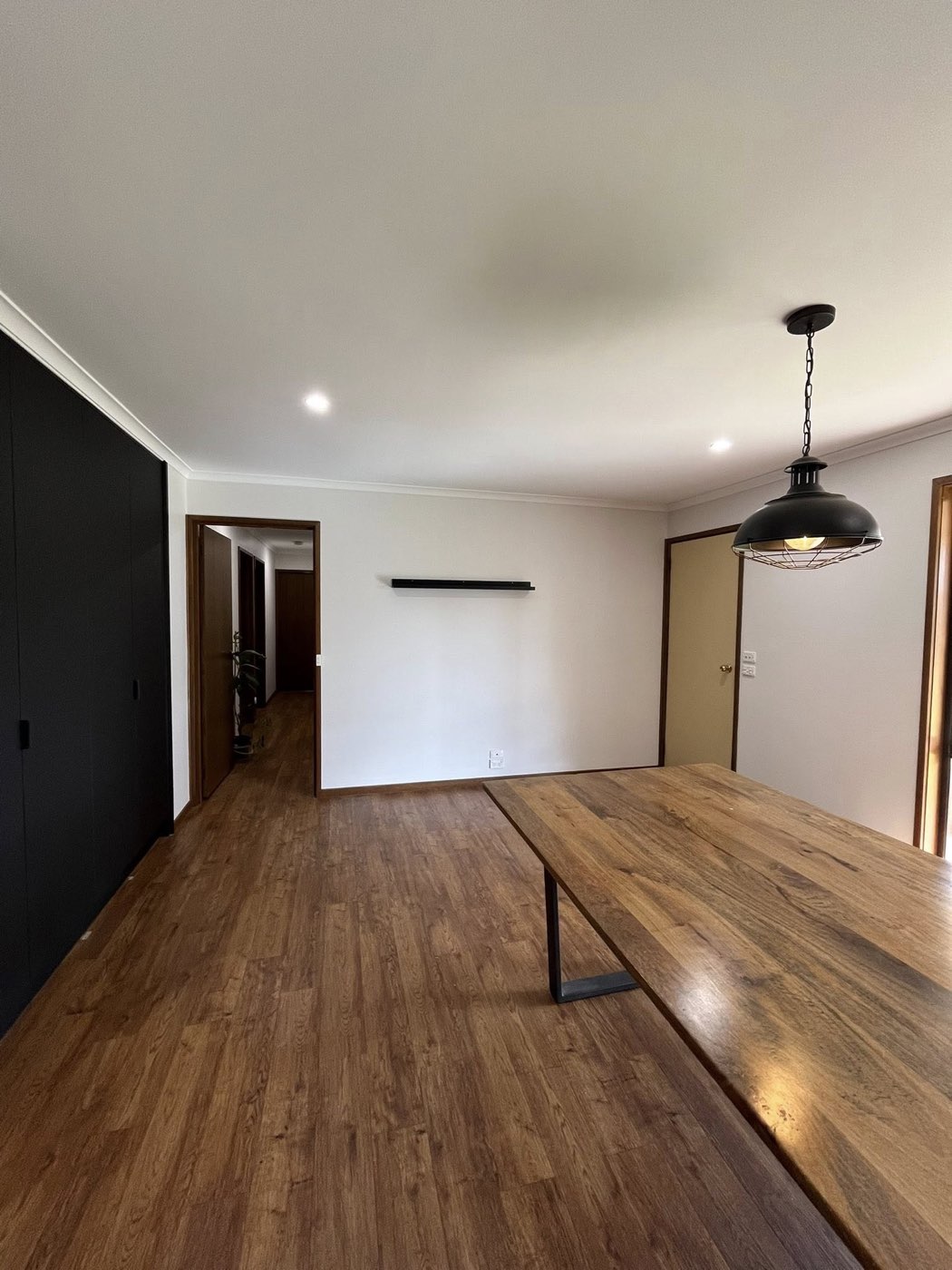 Dining area with industrial pendant and timber table