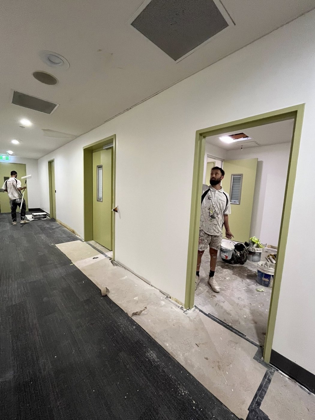 Painter on the brush — commercial fit-out in progress