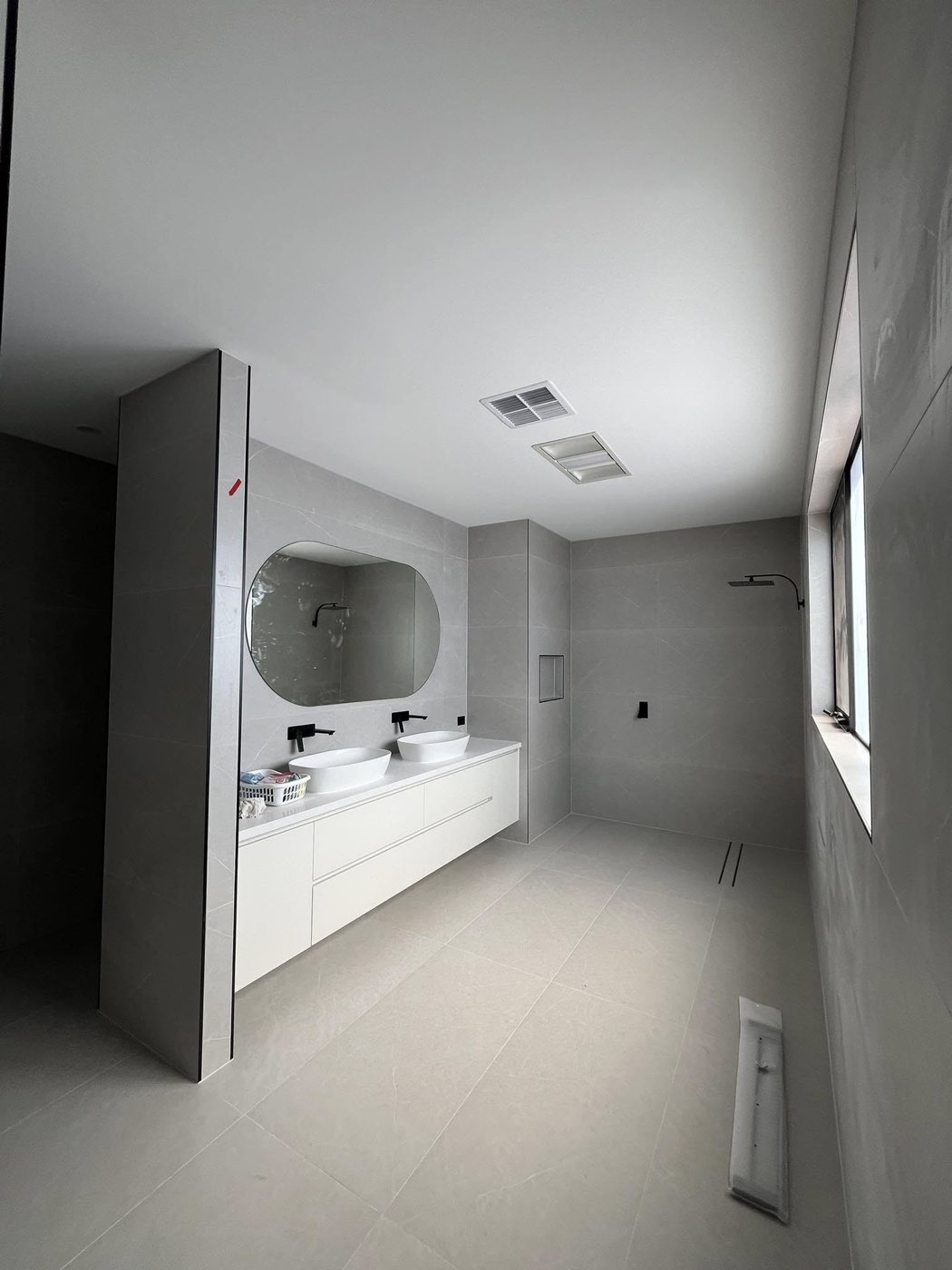 Modern bathroom with double vanity and black tapware