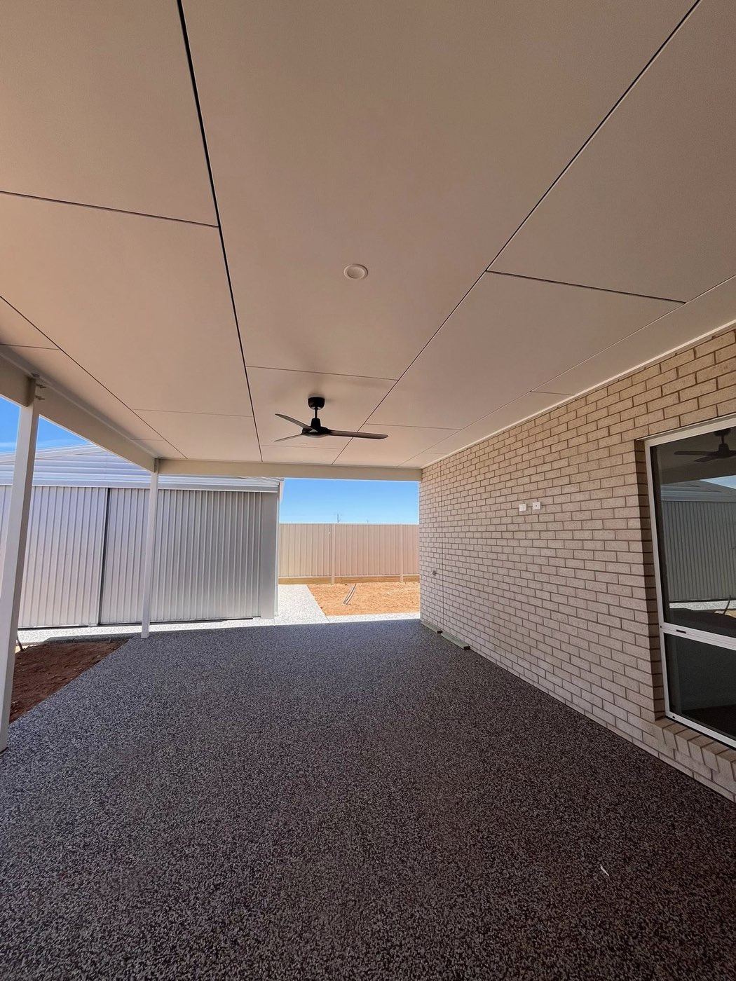 Alfresco patio with brick wall and ceiling fan