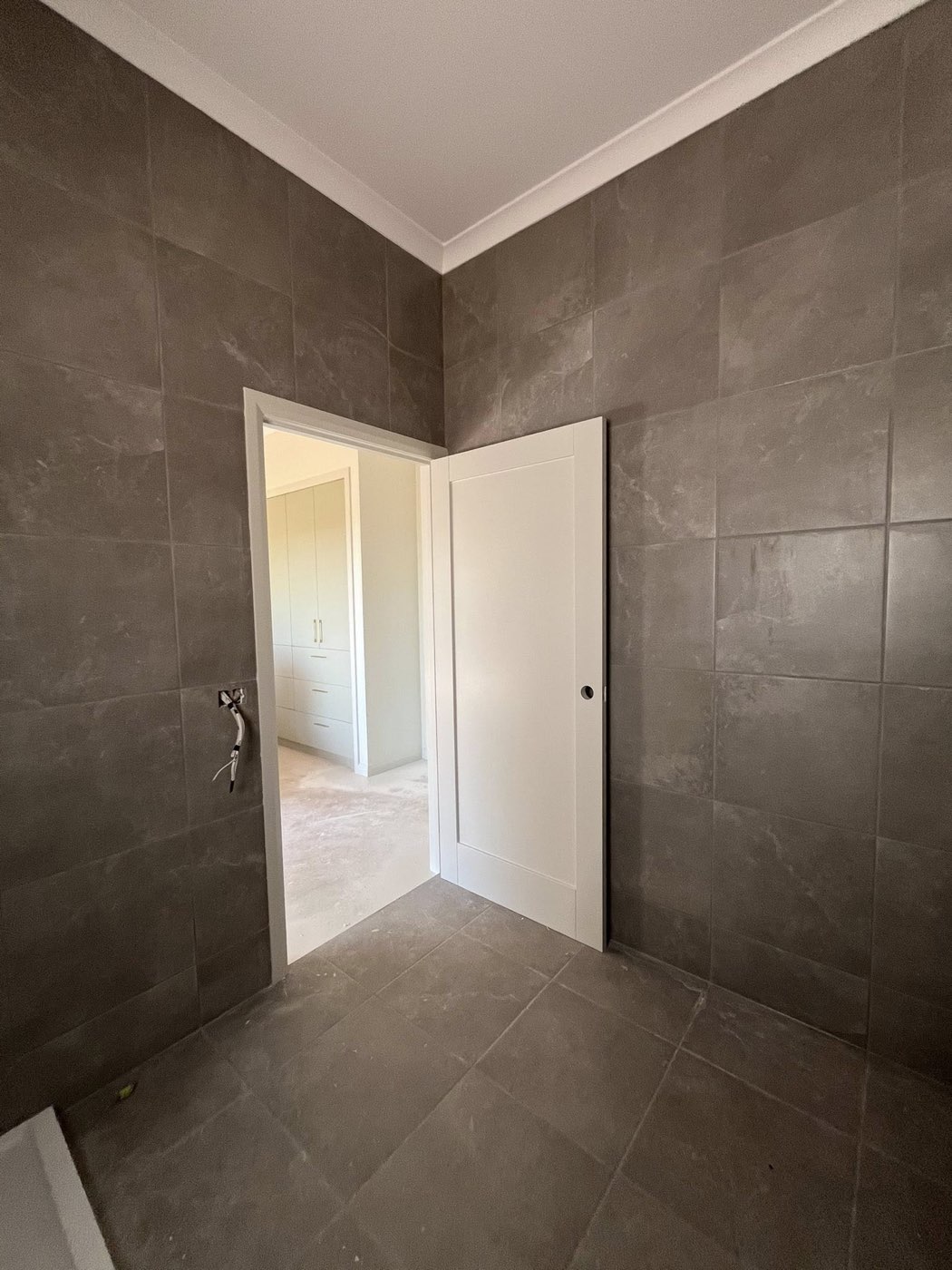Bathroom with dark grey large-format tiles