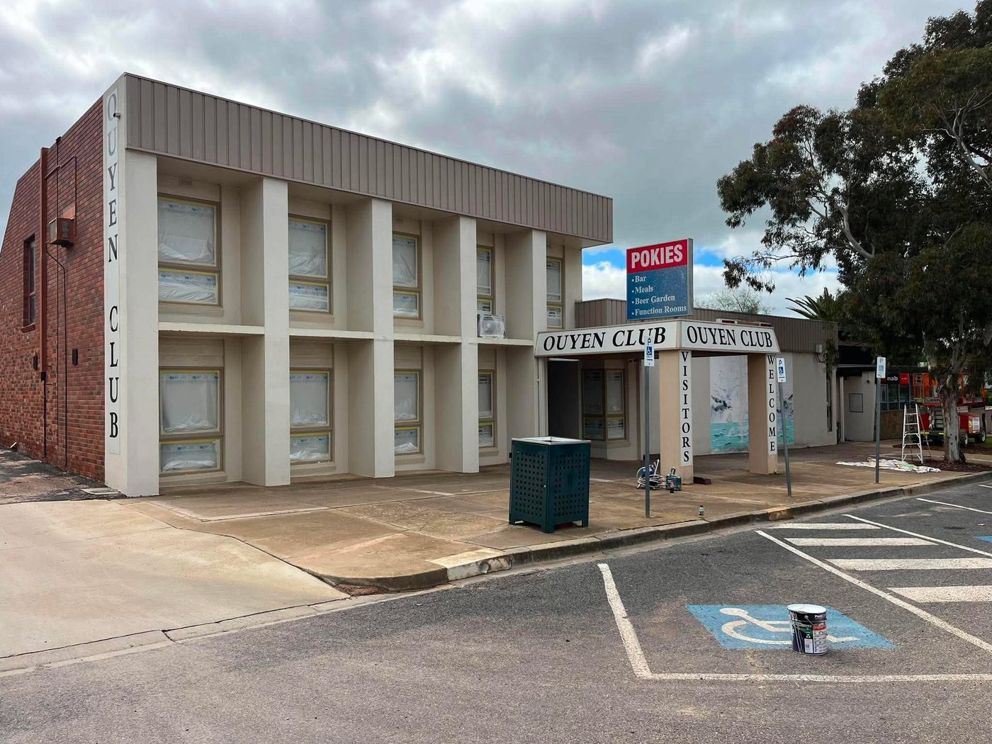Ouyen Club two-storey facade before repaint — tired beige render and brown trim